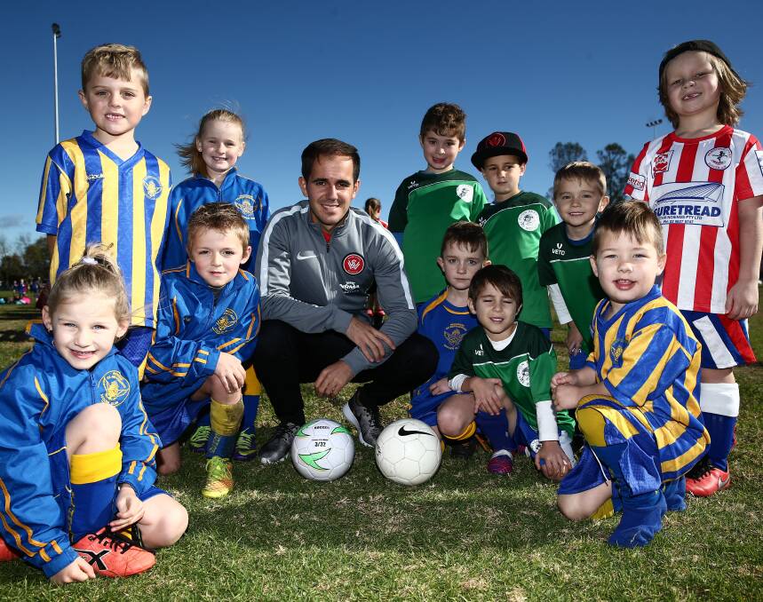 STARSTRUCK: Steven Lustica poses with Richmond, Bligh Park and Wilberforce football juniors. Picture: Geoff Jones
