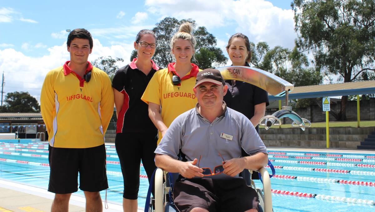 YMCA staff with the outdoor pool hoist, which was installed last year. Picture: Conor Hickey