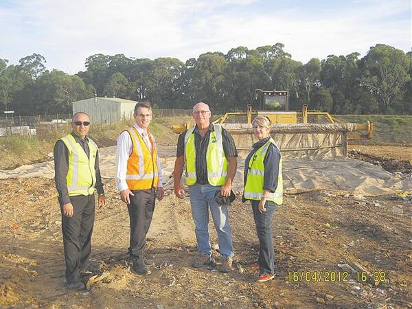 Hawkesbury City Council's waste manager Ramiz Younan and director of infrastructure Jeff Organ, and Hawkesbury councillors Bob Porter and Christine Paine watch the new Tarpomatic in action at at Hawkesbury Waste Depot.