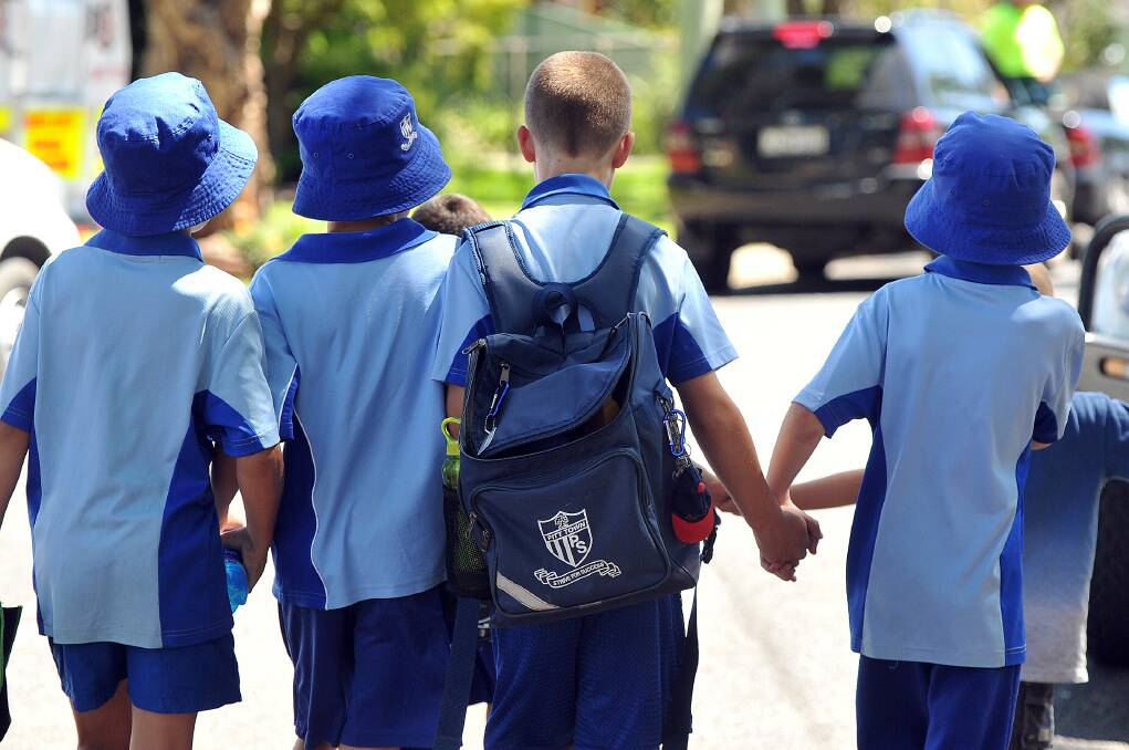 Students console each other after the accident at Pitt Town Public School. Photo: Kylie Pitt.