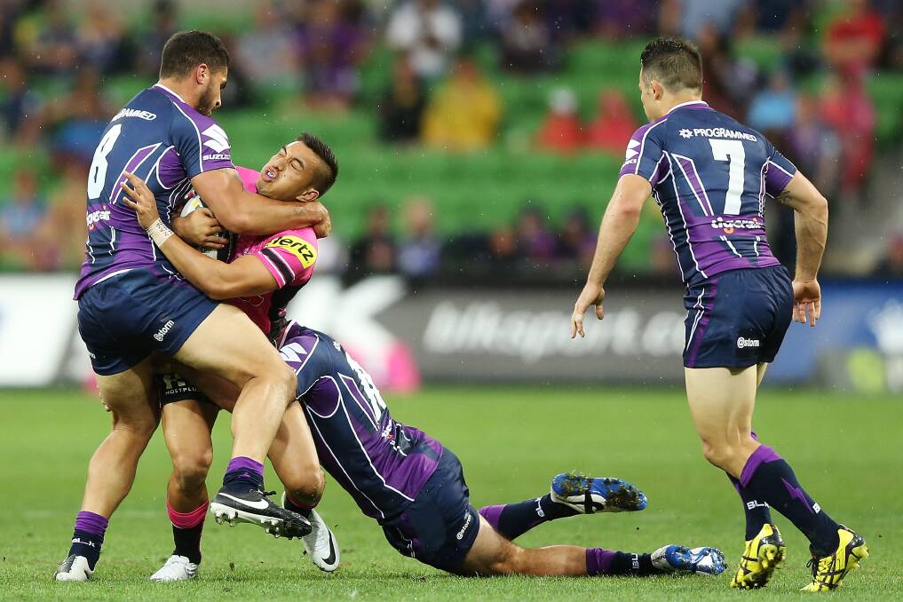MELBOURNE, AUSTRALIA - MARCH 15: Dean Whare of the Panthers is tackled by Jesse Bromwich (L) and Cameron Smith of the Storm during the round two NRL match between the Melbourne Storm and the Penrith Panthers at AAMI Park on March 15, 2014 in Melbourne, Australia. (Photo by Michael Dodge/Getty Images)