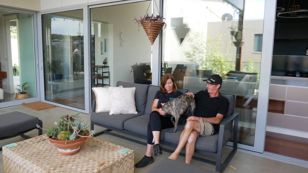 Property owners Peter and Anne Brannelly sit on the upper level patio which also features a hot tub. Photo: Ellouise Bailey
