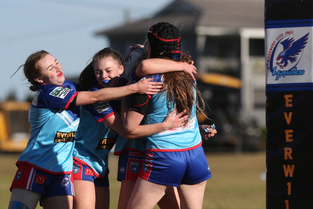 What a try: The team rush to celebrate a try from Ashlie Green in the Under 16 Women's Hawkesbury Hawks debut win against St Mary's at Turnbull Oval, North Richmond. Picture: Geoff Jones. .