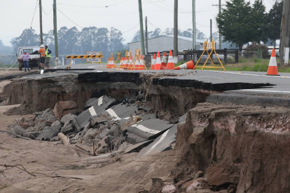 Destroyed: Freemans Reach Road currently under construction after the road collapsed due to flood erosion. Picture: Geoff Jones.