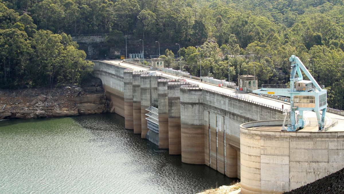 Filling up: Water is slowly being released from Warragamba Dam as levels reach 98.6 per cent of storage capacity. Picture: Chris Lane.