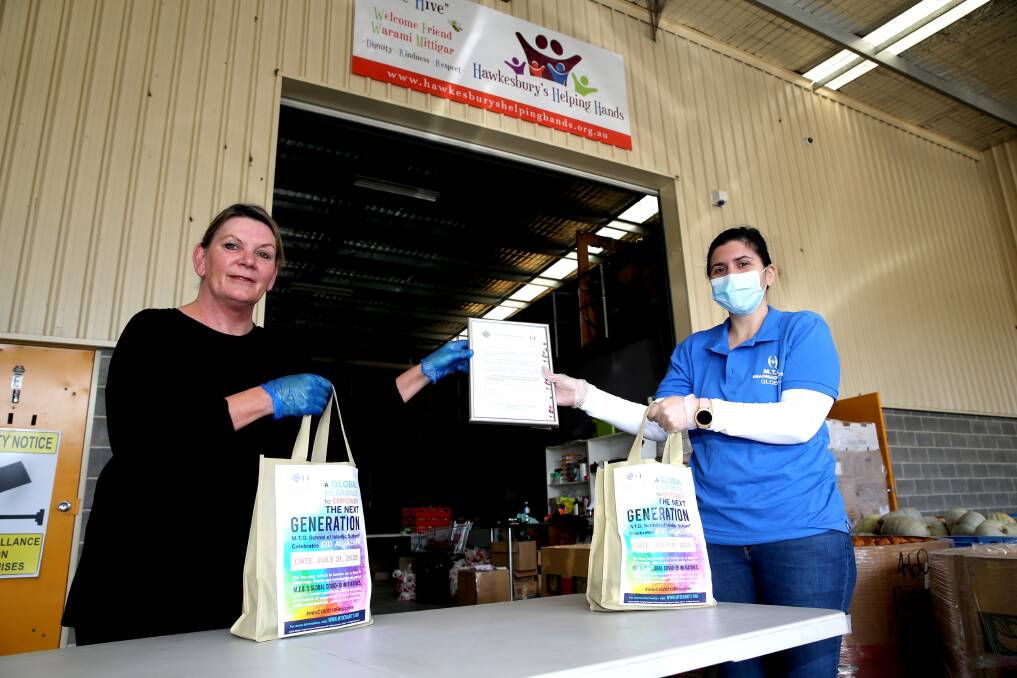 Hawkesbury Helping Hand's Linda Strickland with MTO's Pegah Hadisadegh - MTO handing out donated toiletries at Helping Hands Hawkesbury. Picture: Geoff Jones
