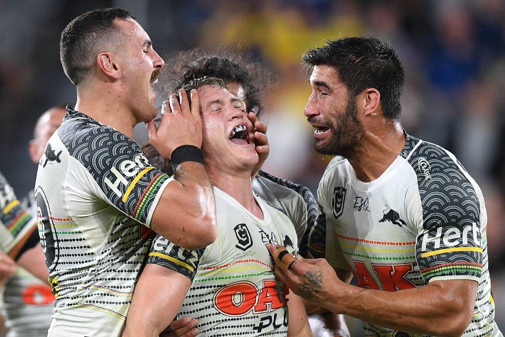 Memorable: Mitchell Kenny (centre) celebrates with Reagan Campbell-Gillard (left) and James Tamou in his debut with the Penrith Panthers. Picture: Dan Himbrechts/AAP