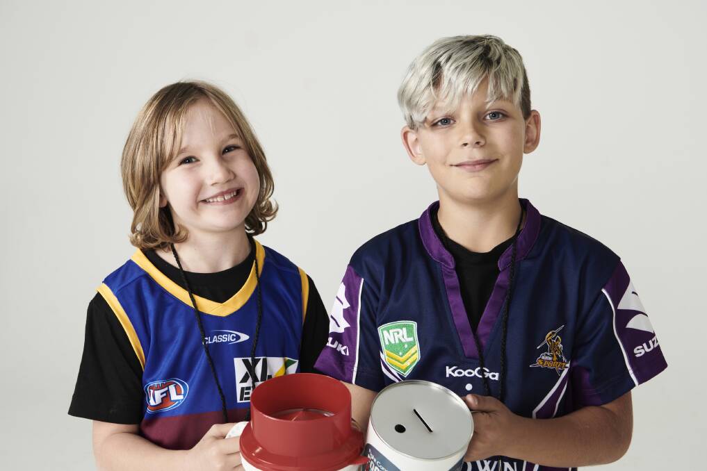Survivors: Footy Colours Day ambassadors Eleanor and Wilberforce's Mason in their footy jerseys. Picture: Supplied.