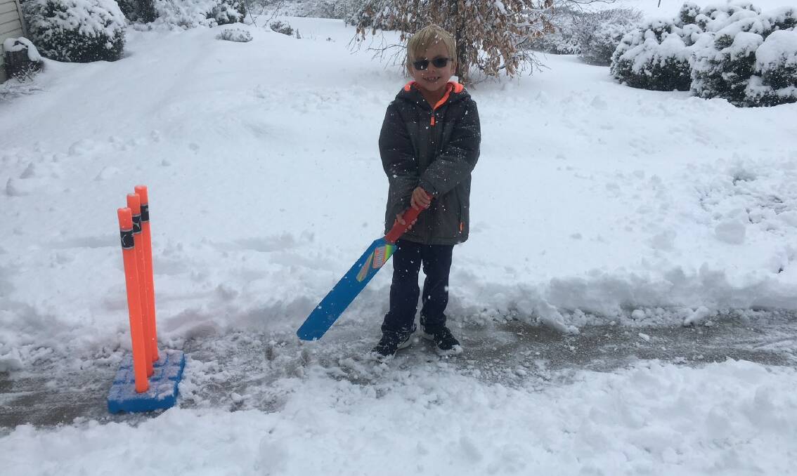 Harsh conditions: Ian playing cricket while it snows in his Wisconsin driveway. Picture: Supplied.