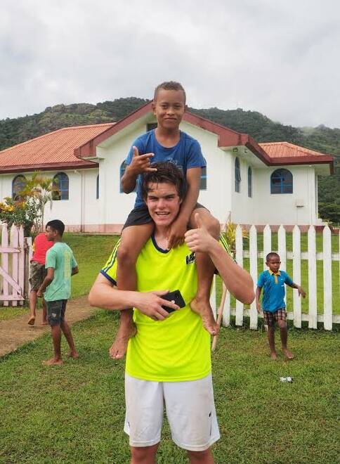 Doing his bit: Howarth spending time with kids from a local Fijian village. Picture: Supplied