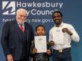 Hawkesbury Deputy Mayor, Barry Calvert, 10-year-old, Emananuellee Oyadeyi, and his father, Temitope Oyadeyi.
