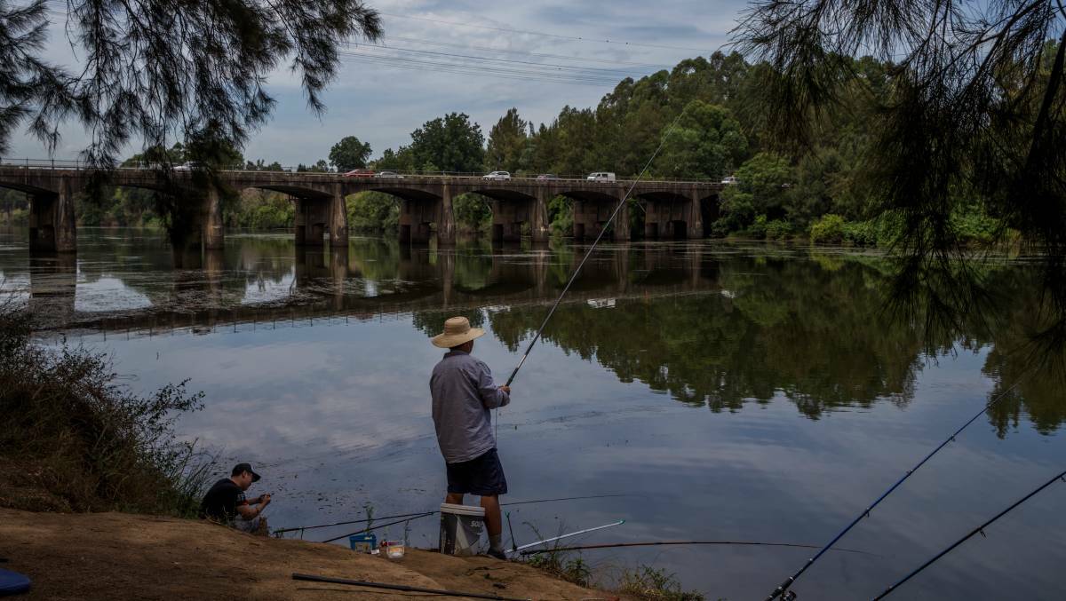 On the banks: People fishing along the Hawkesbury River at North Richmond. Picture: Geoff Jones.