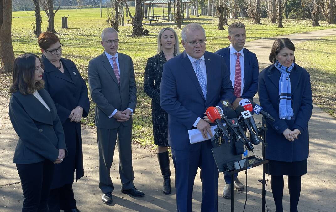 Prime Minister Scott Morrison addresses the media with NSW Premier Gladys Berejiklian (right) and other invested Ministers, MP's and Councillors. Picture: Finn Coleman.