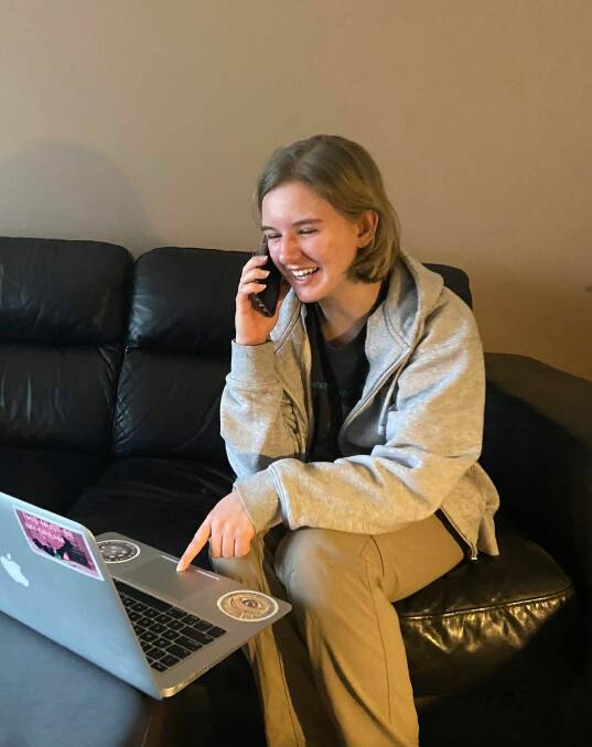 Chloe Tyrell (17) enjoying a phone call with a vulnerable older resident of the Hawkesbury. Picture: Supplied.