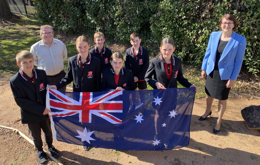 Playground incoming: Macquarie MP Susan Templeman presents the new flag to Richmond North Public School's (L to R) Captain Tyler, Principal Brad Thurling, Vice Captain Chloe, Vice Captain Tristan, Captain Brooke, Vice Captain Lachlan, and Vice Captain Georgia. Picture: Supplied.