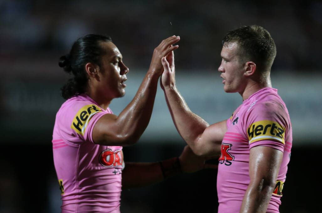 Running it back: Mitch Kenny high-fives teammate Jarome Luai during the Panthers round four match against the Sea Eagles. Picture: Geoff Jones.