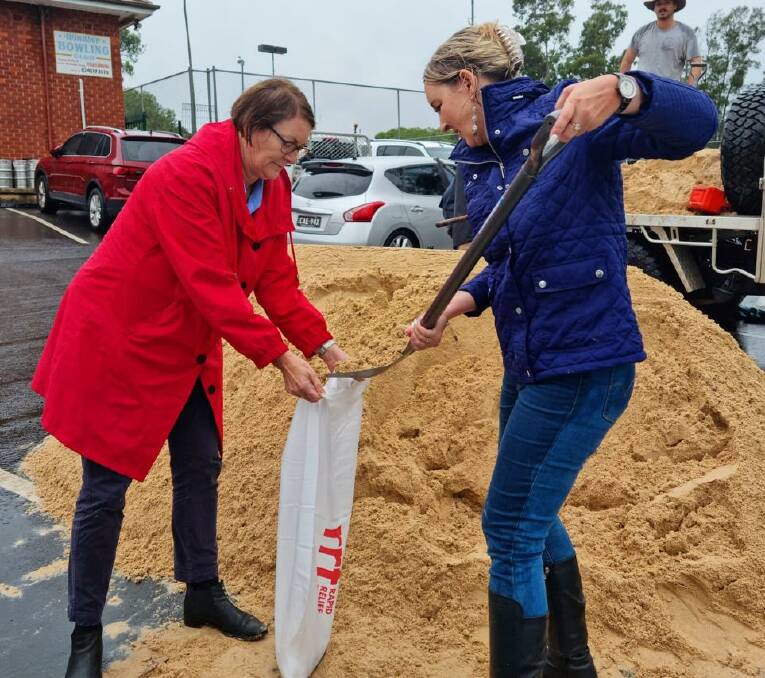 FORGET POLITICS: Macquarie Labor MP, Susan Templeman, and Liberal candidate for Macquarie, Sarah Richards, put aside their politics to fill sandbags at McQuade Park, Windsor on Wednesday. Picture: Supplied.