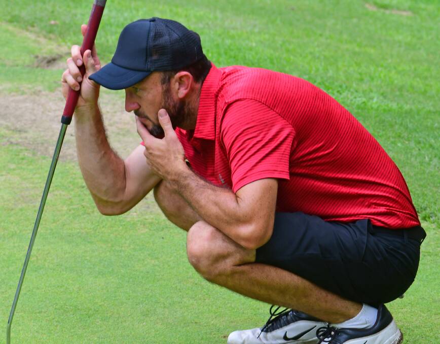 On the green: Windsor Golf Club's Dale Farrugia checks the lay of the green at Leonay in the major pennants. Picture: Noel Rowsell.