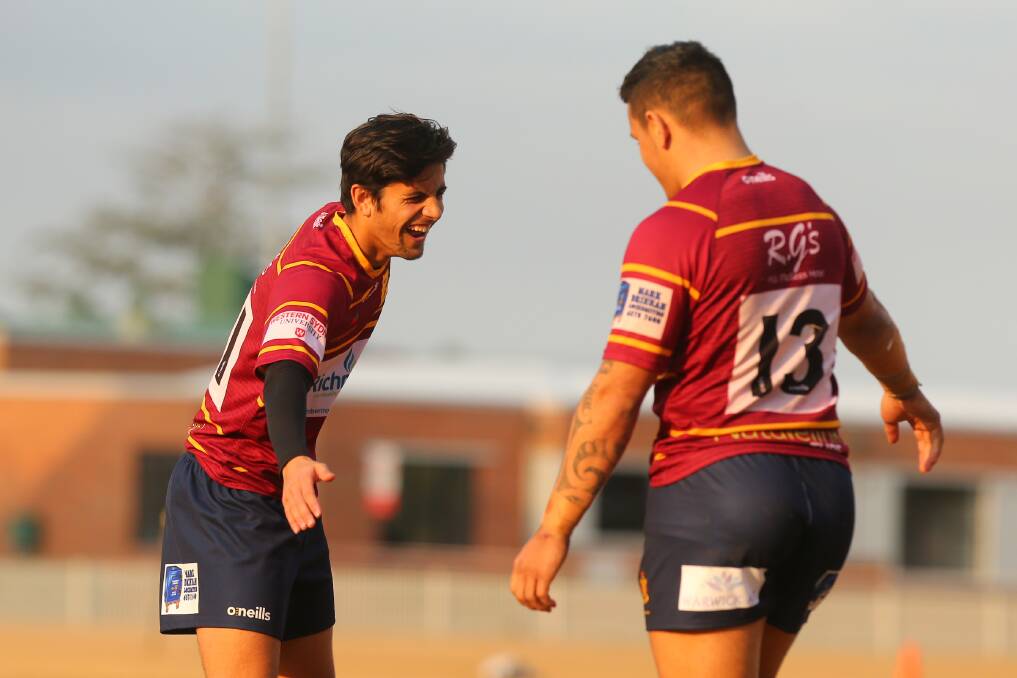 Teamwork: Steven Martin (left) congratulates Colts teammate Johnny Lingoo on his breakaway try while playing for First Grade at home. Picture: Geoff Jones