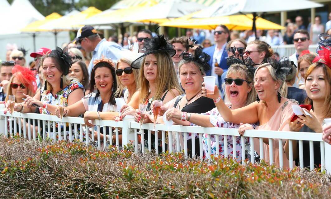 Packed out: Attendees of Ladies Day at Hawkesbury Race Club, all dressed up as they line the fence. Picture: Geoff Jones.