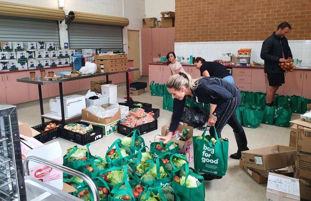 SUPPORT: The Mountain of Joy team prepare hampers of essential goods for St Albans and MacDonald Valley. Picture: Supplied.