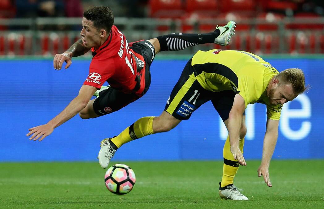 CLOSE: Scott Neville and Conor Pain clash during the 1-1 draw between the Wanderers and Mariners at the weekend. Picture: Getty Images