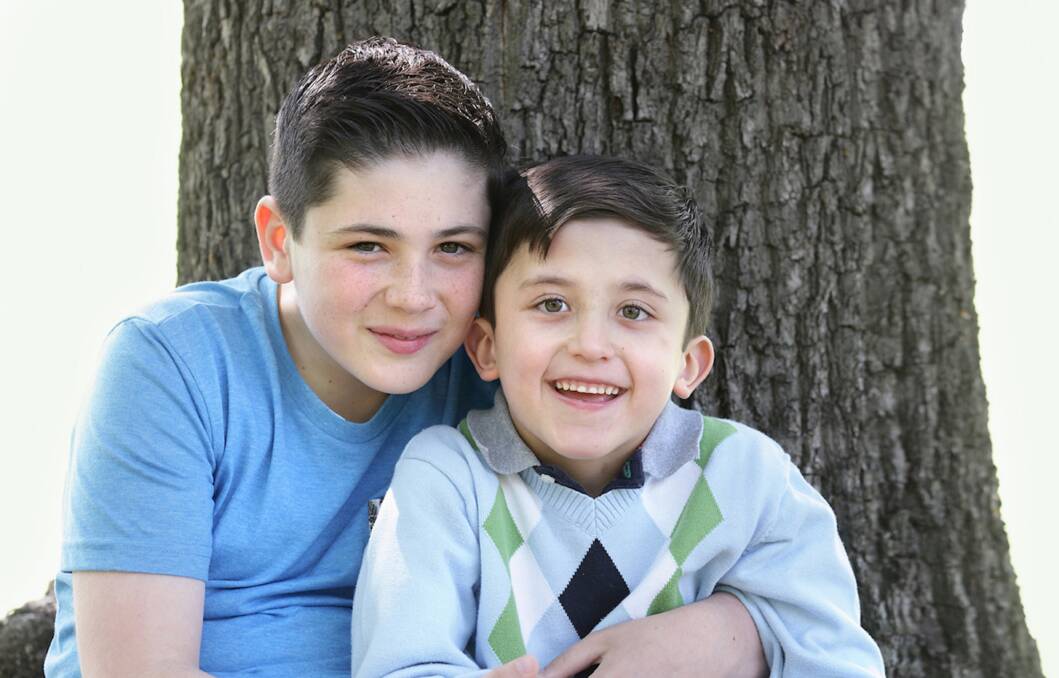 SUPPORT: Alex, seen here with big brother Jonathan (left), has adjusted well to mainstream school and the family is no longer financially burdened.