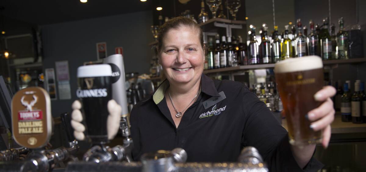 HERE'S CHEERS: Kylie Londish works the bar like a pro at Richmond Club. Pictures: Geoff Jones