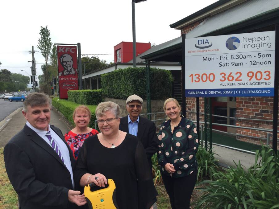 OPEN FOR SAVING LIVES: At front - Gerry and Anne Morgan of Nepean Imaging with the new defib, to be installed in the practice foyer, and at rear Donna Packham and Dr Ravi from Hawkesbury Heartstart and Mayor Mary Lyons-Buckett.