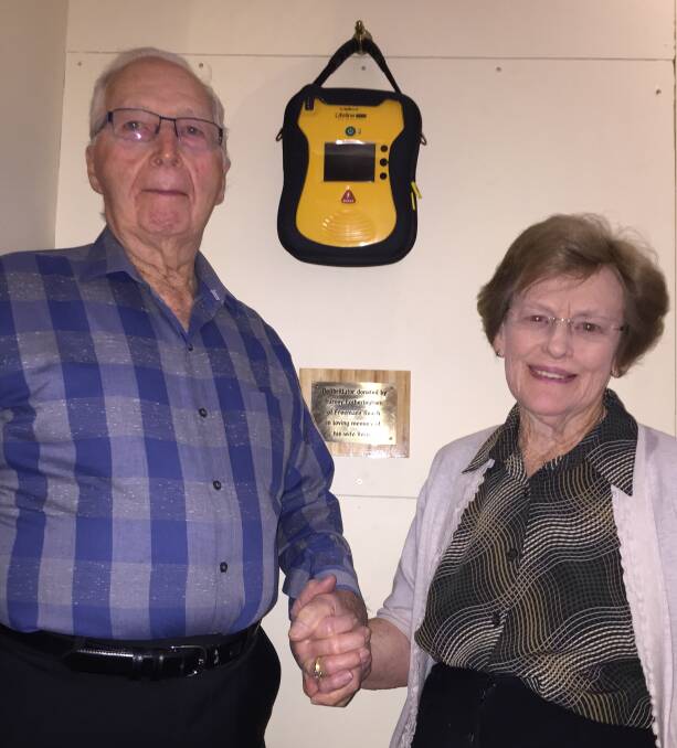 Margaret Thorne of Richmond School of Arts thanks Harvey Fotheringham for the lifesaving device he donated in memory of his wife Verna. A plaque saying as much is under the device.