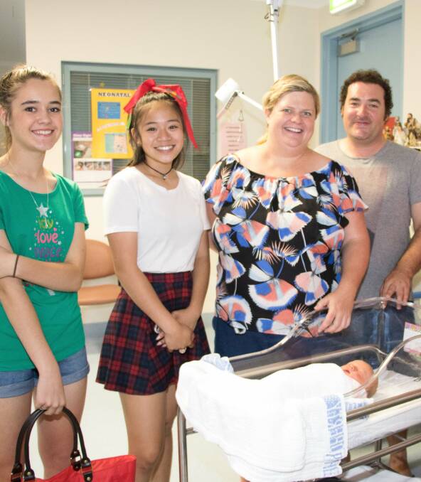 Choir students Faith Shelley, Paige Peter (and Arielle Sow, not in picture) were selected to present a Christmas gift for parents Samantha Holland and Lloyd Murray's newborn Katie in the Special Care Nursery. 