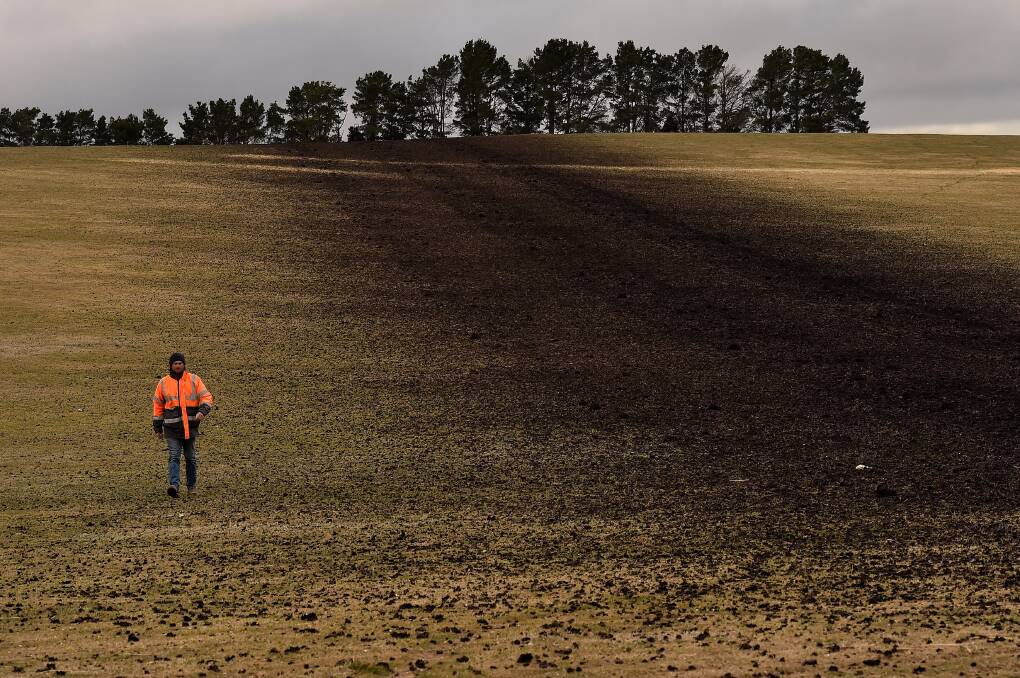 Farmer Stuart Kelly oversees biosolids being added to a paddock at his farm in the central west, near Blayney. Later that day it was ploughed in, a process Mr Kelly described as "pushing s---t  uphill". Picture: Kate Geraghty