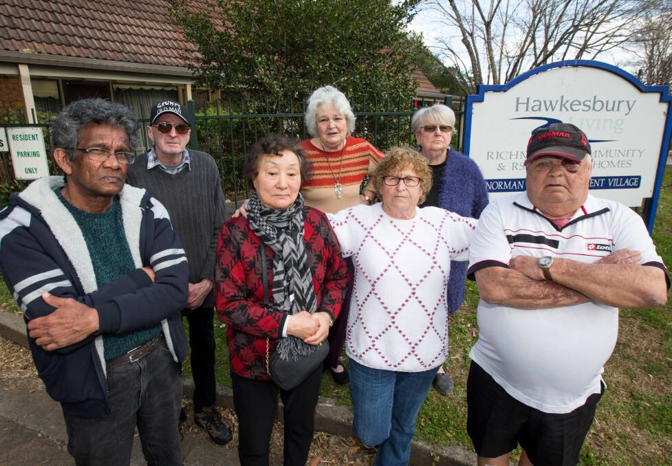 Some of Norman Court's residents outside their complex on Windsor Street last month. Picture: Geoff Jones