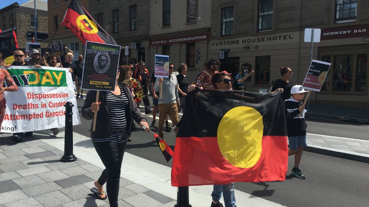 Protesters walk through the streets of Hobart at an Invasion Day rally in 2017. 