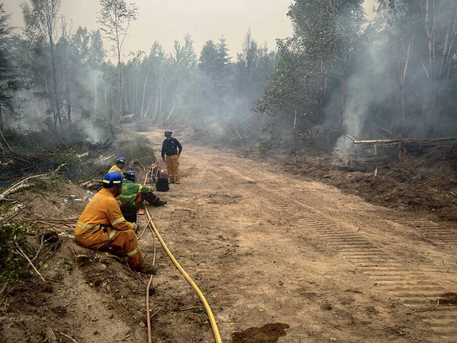 Firefighters taking a break at the Bassett fire. Picture supplied.