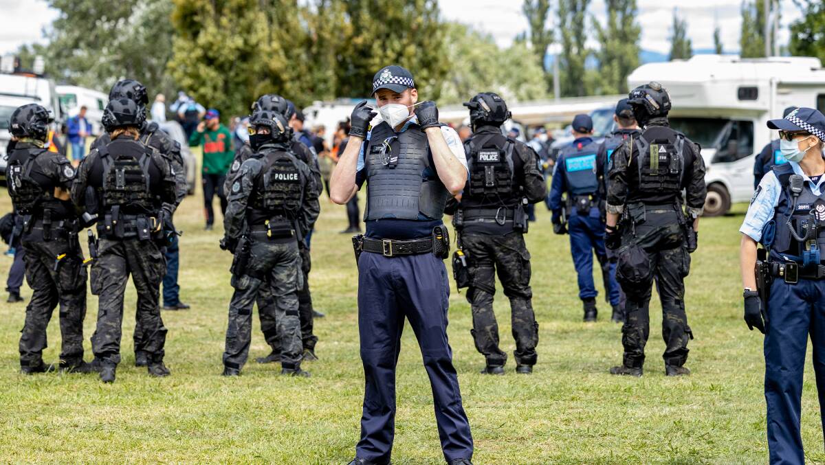 A large contingent of police officers cleared an illegal camp of hundreds of anti-vaccine mandate protesters outside the National Library of Australia on Friday morning. Picture: Sitthixay Ditthavong