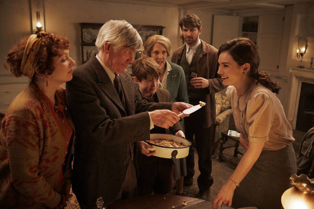 Makeshift family: Katherine Parkinson, Sir Tom Courtenay, Kit Connor, Penelope Wilton, Michiel Huisman and Lily James in the Guernsey Literary and Potato Peel Pie Society, rated M, in cinemas now.