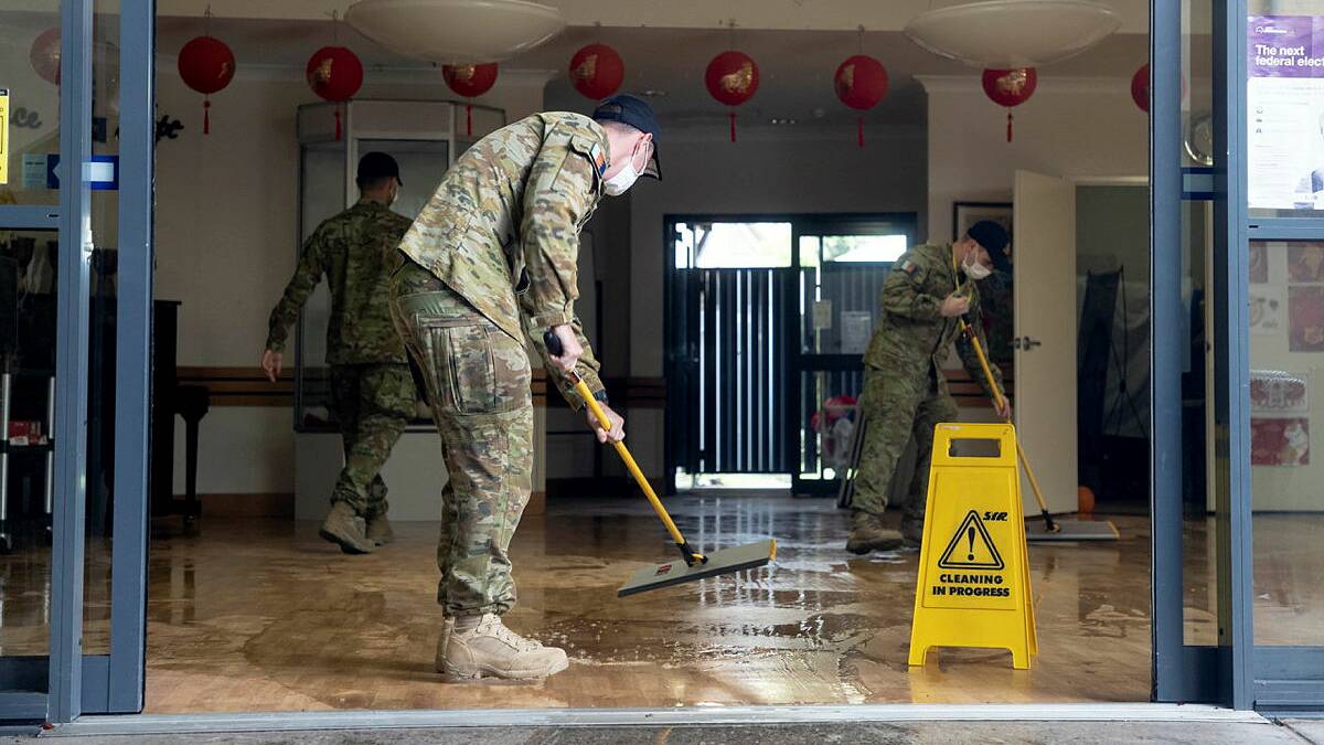 Australian Army soldiers from 5th Battalion, Royal Australian Regiment, assist a flood-affected nursing home in Brisbane, Queensland.
