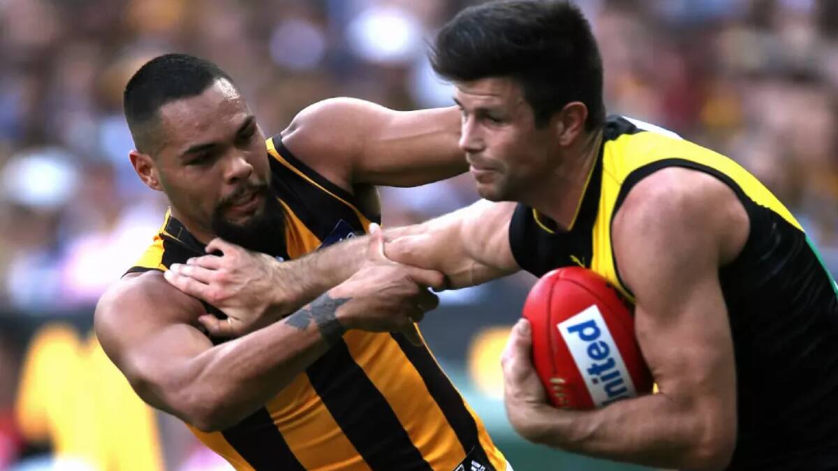 Trent Cotchin fended off Jarman Impey when the Tigers and the Hawks met earlier this season. Photo: Wayne Ludbey