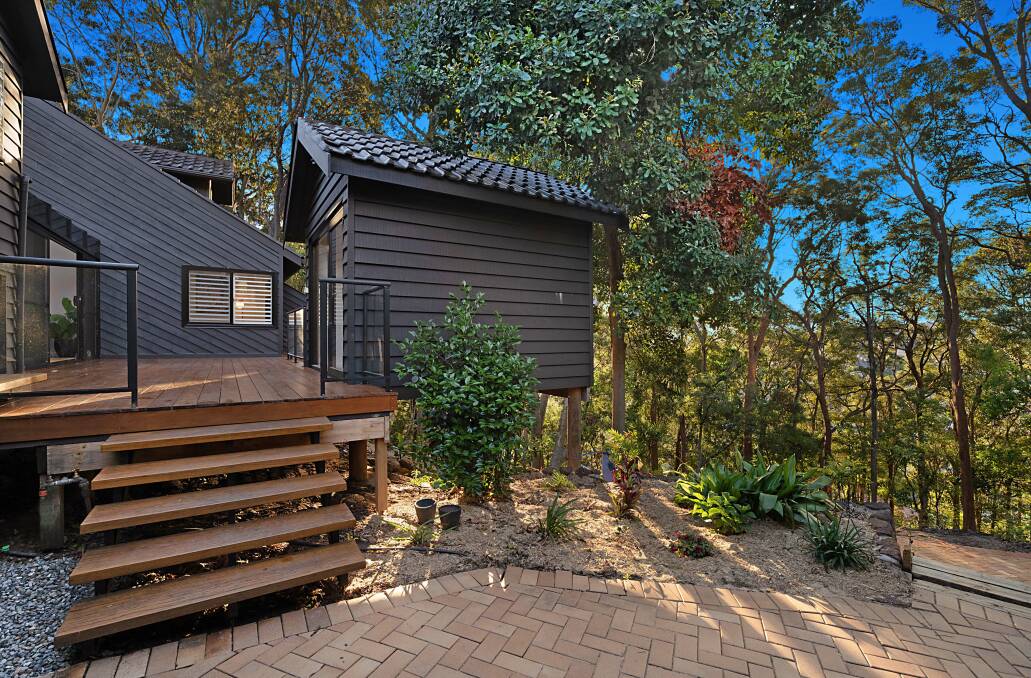This exterior room, perfect for a home office, sits nestled under a macadamia tree. 