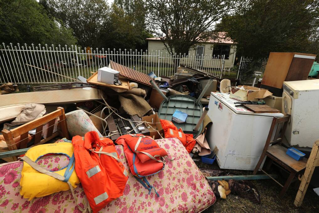 Help at hand: Items damaged by flood are piled outside a Hawkesbury property. Picture: Geoff Jones