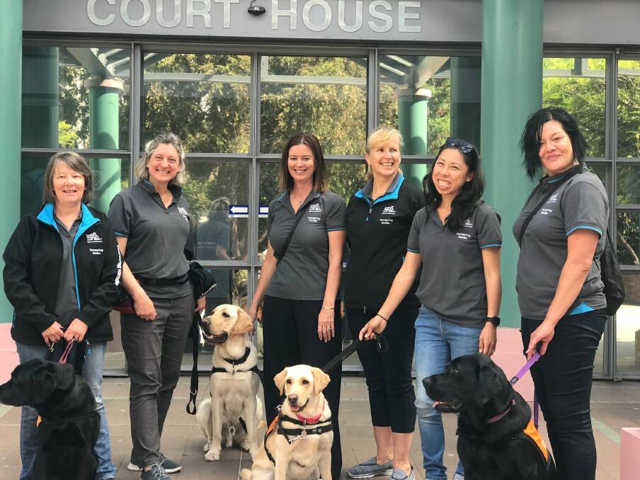 Therapy dog work: A selection of the Volunteer Team of the Year Award winners with their Canine Court Companion Program at Burwood Court. Picture: Supplied