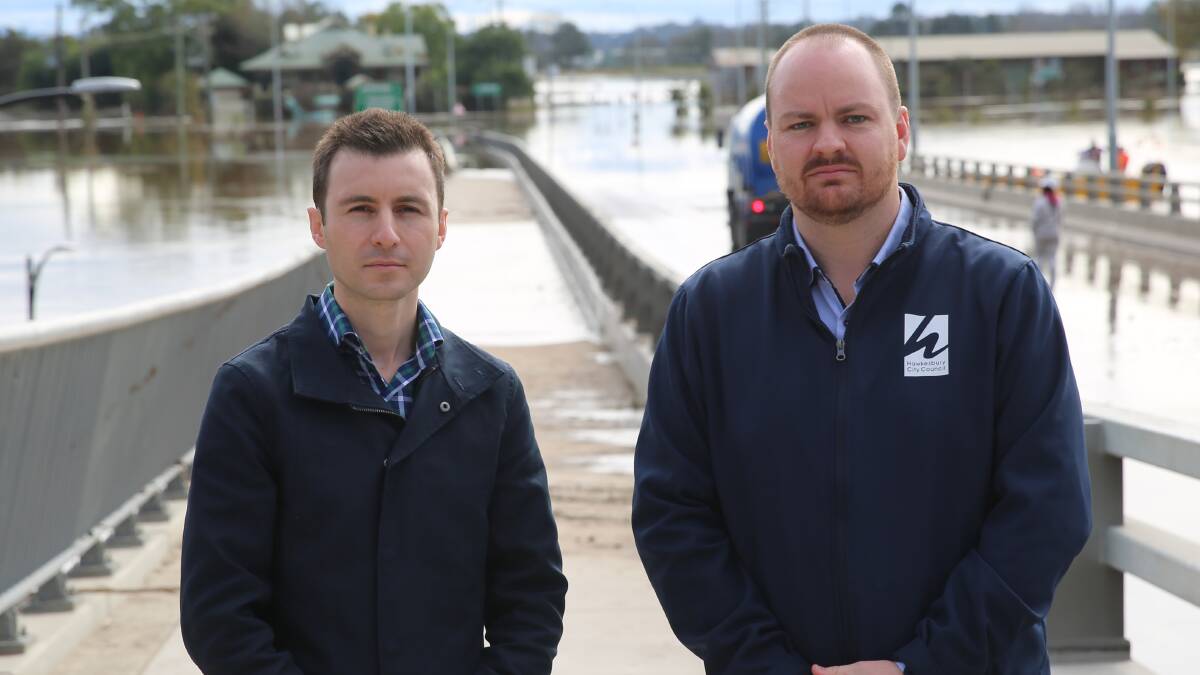 Mayor of The Hills Shire, Dr Peter Gangemi , with Hawkesbury Mayor, Patrick Conolly at Windsor Bridge during the recent floods. They are calling for the Warragamba Dam wall to be raised. Picture: Supplied