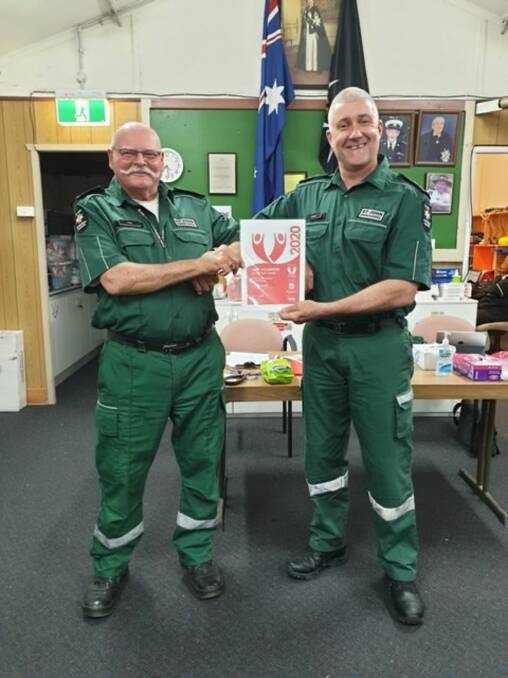 Andrew North (right) with St John Ambulance Hawkesbury City Division Officer in Charge, Paul Barber, presenting a volunteer award. Picture: Supplied