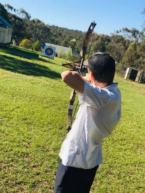 A Peer Me Up client gets help with his archery. Picture: Supplied