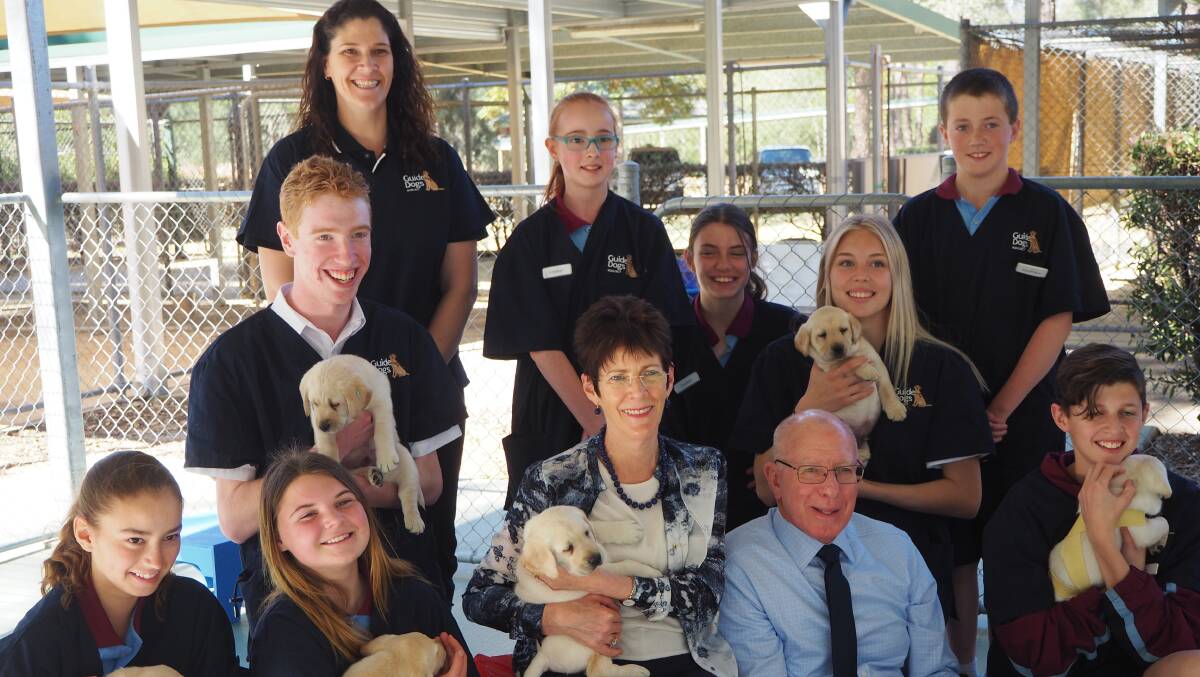 PUPPY LOVE: NSW Governor David Hurley with Hawkesbury High School students at the Guide Dogs Centre in Glossodia in 2017. Picture: Supplied