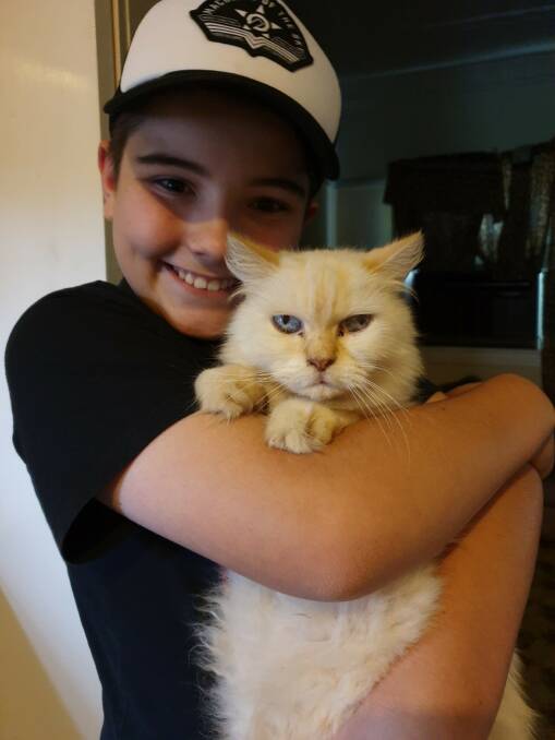 Minke the cat and 12-year-old Damien of Richmond