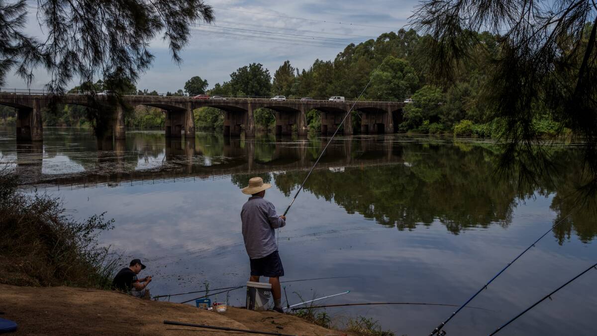 Consumption: People fishing from the banks of the Hawkesbury River at North Richmond. EPA has advised safety remains unchanged from PFAS. Picture: Geoff Jones