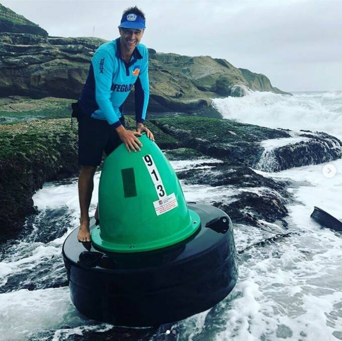 Flood treasure: Gavin Stevenson stands atop the Upper Colo starboard marker that floated out to Bronte Beach during the floods. Picture: Instagram @bagjuan