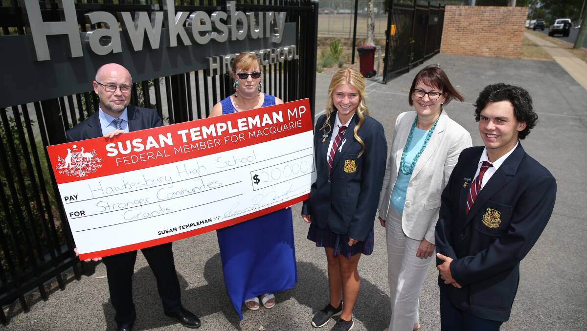 COMMUNITY WILL BENEFIT: Federal Member for Macquarie Susan Templeman presents a cheque to Hawkesbury High principal Igor Maric, P&C's Sandy Whitney and captains Michael Boylan and Ashlee Scott as part of the Stronger Communities grants scheme. Picture: Geoff Jones